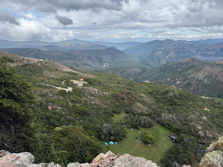 High-angle view of a mountain campsite with tents and a green valley landscape - Vina Waterfall, Lara, Venezuela