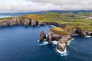 Rocky coastline with steep cliff faces, Sao Miguel, Azores, aerial view. Atlantic waves breaking at base of coast