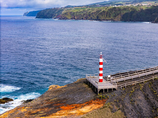 Lighthouse on scenic Atlantic ocean coast of Sao Miguel Island Azores archipelago, Aerial drone shot