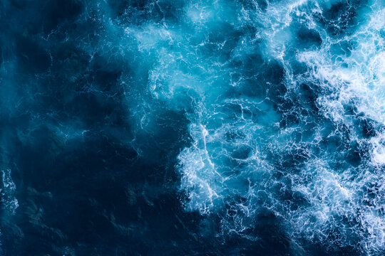Rough sea surface with continuous whitewater, aerial view. Textured ocean backdrop