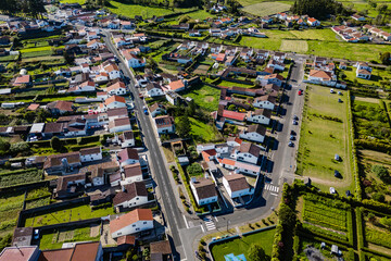 Aerial view of Sete Cidades village with white houses, narrow streets and green gardens on Sao Miguel island, Azores
