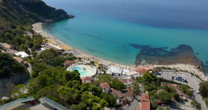 Aerial view of Grotticelle beach, located on the Costa degli Dei, Calabria, Italy. On the right, on the horizon, is the promontory of Capo Vaticano, overlooking the crystal-clear sea.