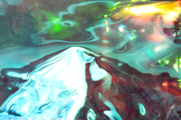 Vibrant abstract colors swirl across a glossy surface with luminous greens, blues, and reds