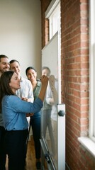 Vertical shot of creative business team brainstorming on whiteboard, young woman writing ideas during office meeting, teamwork and project planning concept