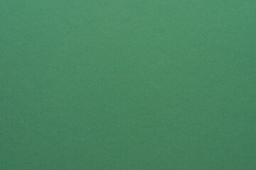Green paper texture background, vintage cardboard surface close up