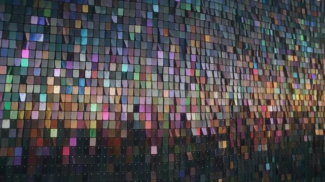  rotating facade composed of thousands of tiny glass like tiles shimmering in rainbow reflections