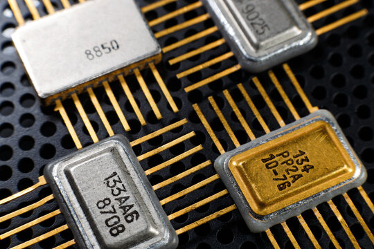Vintage integrated circuits and microchips with gold pins. A detailed macro photograph of old computer microchips.  