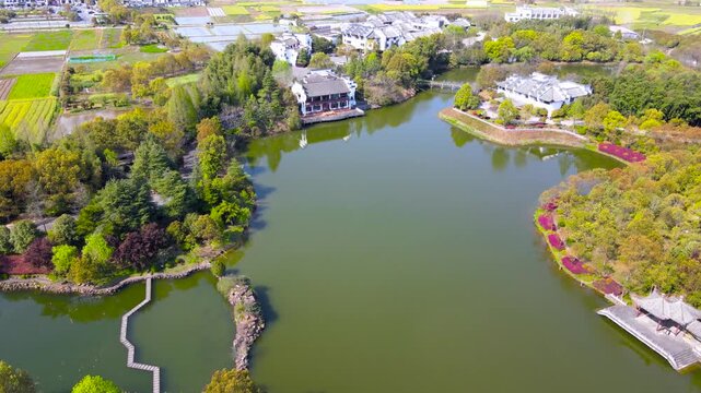 Aerial View of Luxury Waterfront Estates and Spring Gardens by Lake