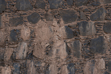 Ancient rustic volcanic stone wall texture background for design