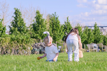 Kids Hunting Easter Eggs Outdoors on Sunny Spring Day