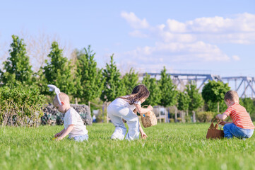 Kids Hunting Easter Eggs Outdoors on Sunny Spring Day