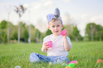 Smiling Boy Celebrating Easter Outdoors with Egg Hunt Basket