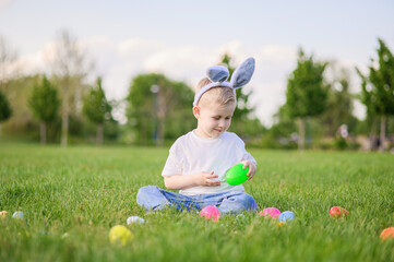 Smiling Boy Celebrating Easter Outdoors with Egg Hunt Basket