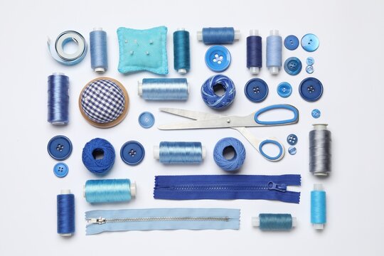 Flat lay composition with sewing supplies on white background