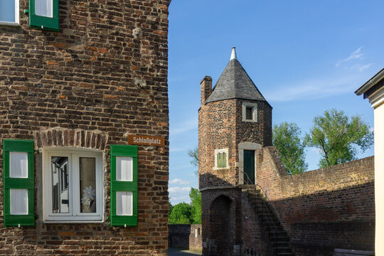 Historic Medieval Architecture of Zons Germany featuring Fortification Tower and Brick House with Green Shutters