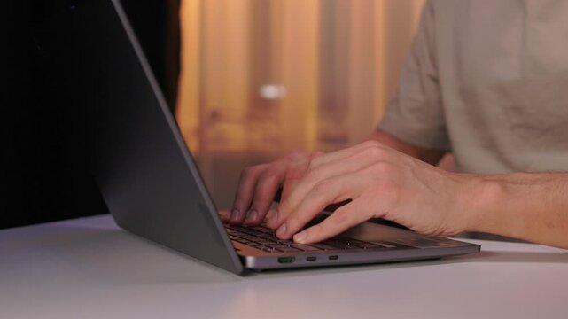 Developer working under dim light. Night coding session with glowing screen and quiet ambiance. Focused programmer typing code during late night debugging under subtle lighting