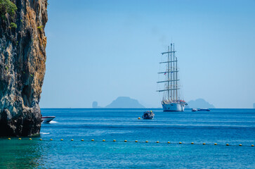 A yacht sails among the tropical rainforest mountains island in Krabi Province,  South Thailand, Asia. Thailand archipelago islands