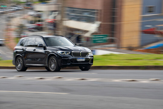 Black BMW X5 in movement, Luxury SUV driving on city road