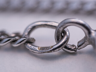 A silver circular chain clasp on a white background.