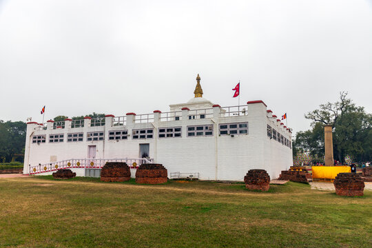 Lumbini, Rupandehi, Nepal  Exterior view of Maya Devi Temple, the sacred birthplace of Siddhartha Gautama (Buddha), with Ashoka Pillar and archaeological remains in Lumbini World Heritage Site.