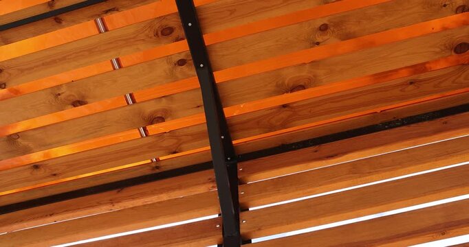 a frame made of logs and planks on the beach , a wooden frame building under construction on the beach to create a good infrastructure for recreation, a canopy made of planks