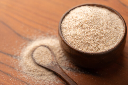 Psyllium husks or isabgol in a bowl on the table. Dietary supplement, superfood which is rick in fiber.