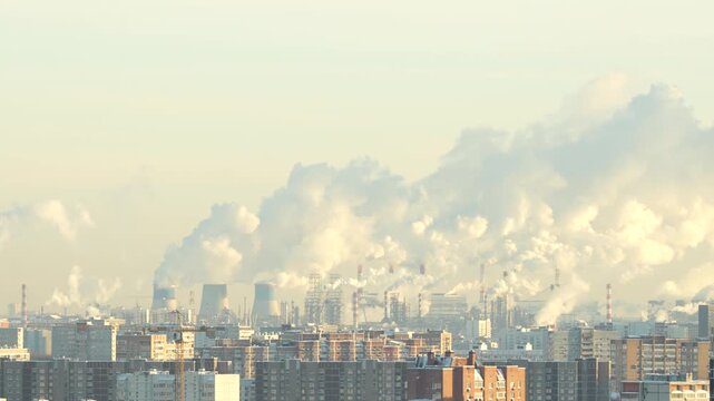 Industrial city skyline with factory smokestacks emitting heavy smoke over residential buildings, air pollution and environmental impact concept during cold season
