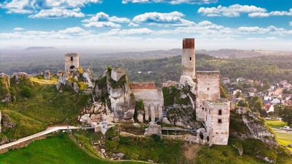 Castle ruins in Olsztyn near Częstochowa captured in golden hour light, aerial drone view over limestone rocks and historic fortress in Poland © Konrad Kerker