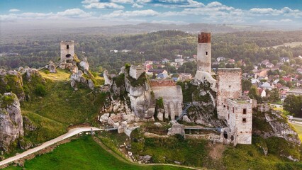 Castle ruins in Olsztyn near Częstochowa captured in golden hour light, aerial drone view over limestone rocks and historic fortress in Poland © Konrad Kerker