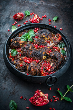 Traditional authentic Persian khoresh fesenjan - chicken stew with walnut and pomegranate sauce served as close-up in a design pot