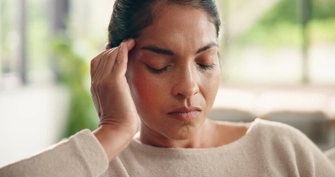 Headache, tired and stress with woman in home for frustrated, fatigue and brain fog. Migraine pain, worry and temple massage with person in living room of apartment for crisis and overwhelmed