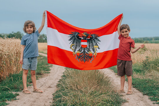 Joyful Kids, Boys Stands In Ripe Wheat Field Holding Austrian Flag, Austria