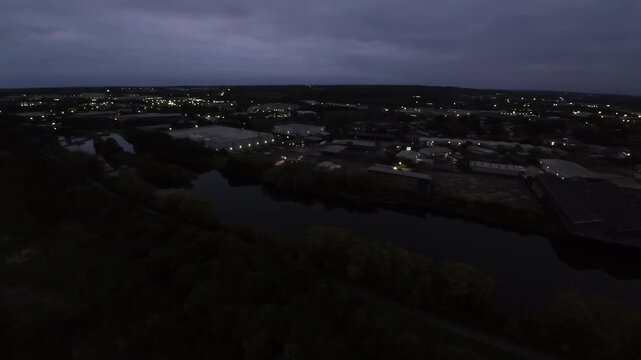 Leeds, UK Riverside Panorama At Dusk Over Leeds, Canal And River Reflecting City Lights, Cloudy Horizon, Distant Warehouses And Suburban Sprawl, Calm Water And Moody Evening Sky