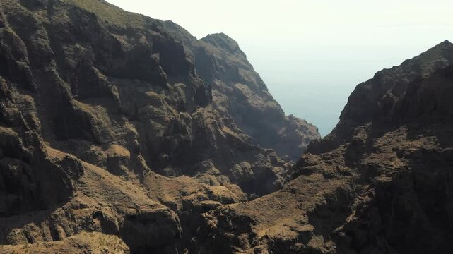 Flying over Masca Valley with ocean in the distance, Tenerife, Spain