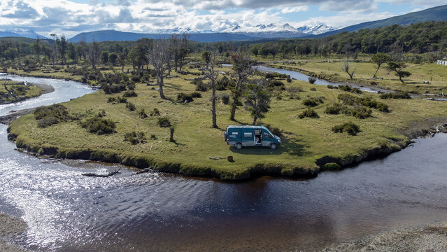 Modern overlanding lifestyle in remote nature. Drone shot of camper van embracing freedom, minimalism and connection with the outdoors.