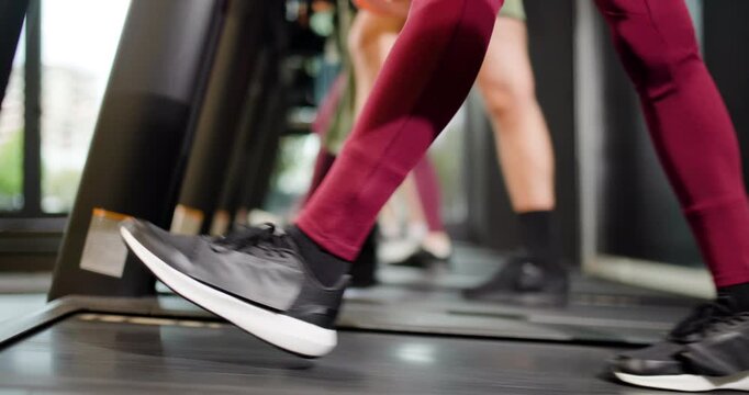 Fitness friends work out together at the exercise center with group activities focusing on walking on treadmills during morning hours