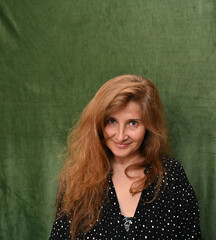 Woman with long hair on a green background,