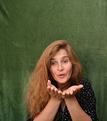 Woman with long hair on a green background,