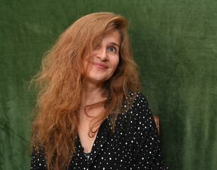 Woman with long hair on a green background,