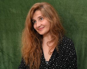 Woman with long hair on a green background,