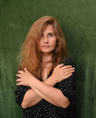 Woman with long hair on a green background,
