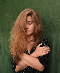 Woman with long hair on a green background,