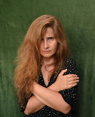 Woman with long hair on a green background,