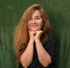 Woman with long hair on a green background,