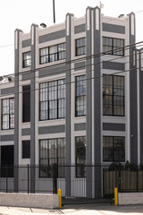 Fototapeta premium Afternoon sun shines on historic industrial buildings in the heart of Vernon, California, USA.