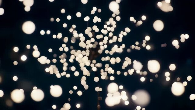 Magical 3D abstract animation of a flower shape defined by shimmering bokeh light particles.