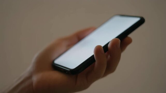 Close up of a persons hands using a smartphone with a bright screen. 4k Footage Video