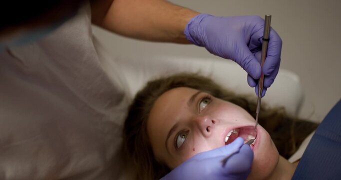 Closeup of dental procedure at clinic in Europe with patient receiving care from dentist