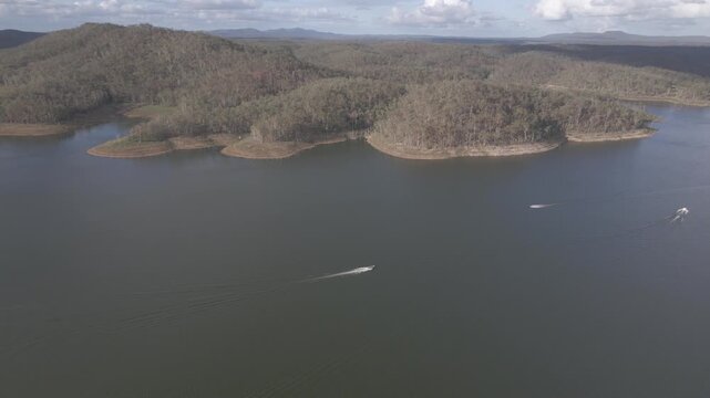 Panning aerial of boats moving on Lake Monduran by Fred Haigh dam