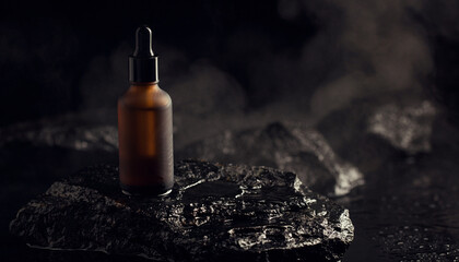 Premium men's grooming oil bottle on dark stone with atmospheric smoky effect